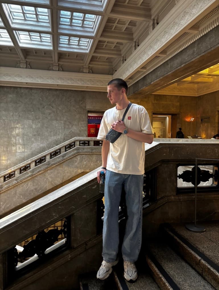 Matvey Dmitriev standing inside an ornate marble hall